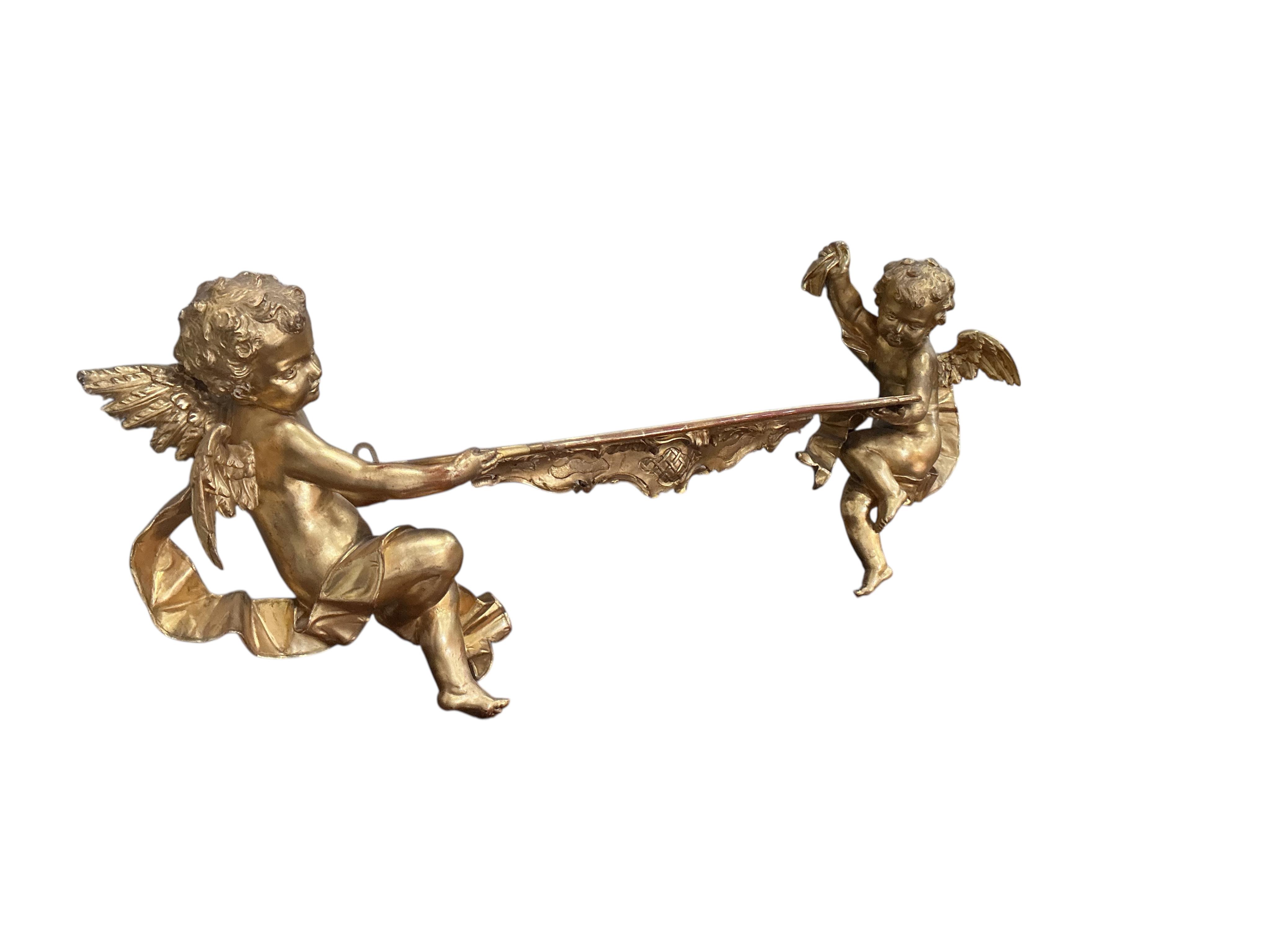 A Victorian style giltwood and composition cherub wall bracket, width 102cm, height 38cm